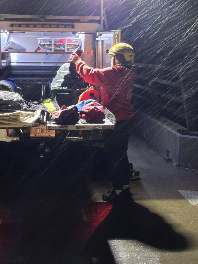 Preparing equipment in cold rain